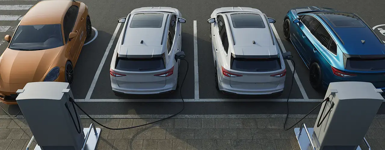 Electric cars plugged into a charging station, showcasing multiple vehicles charging simultaneously.