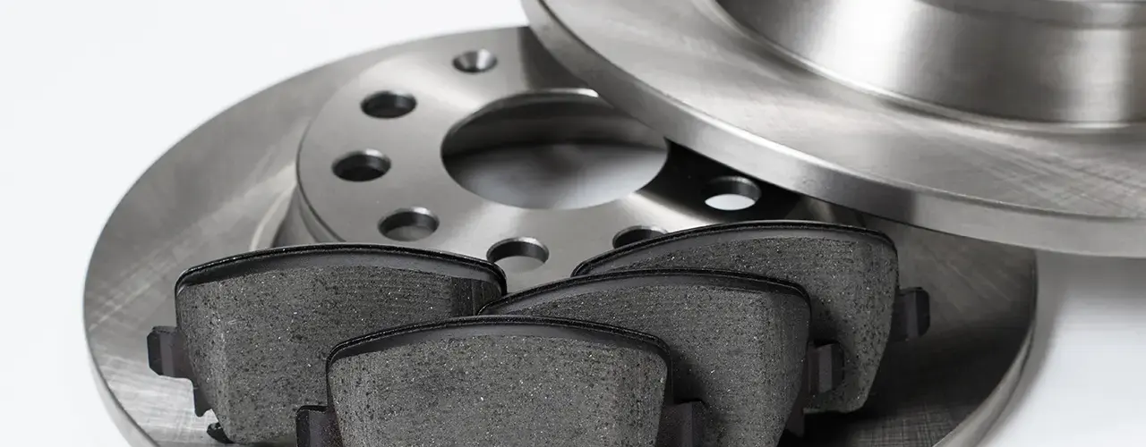 Brake pads and discs placed on a white background.