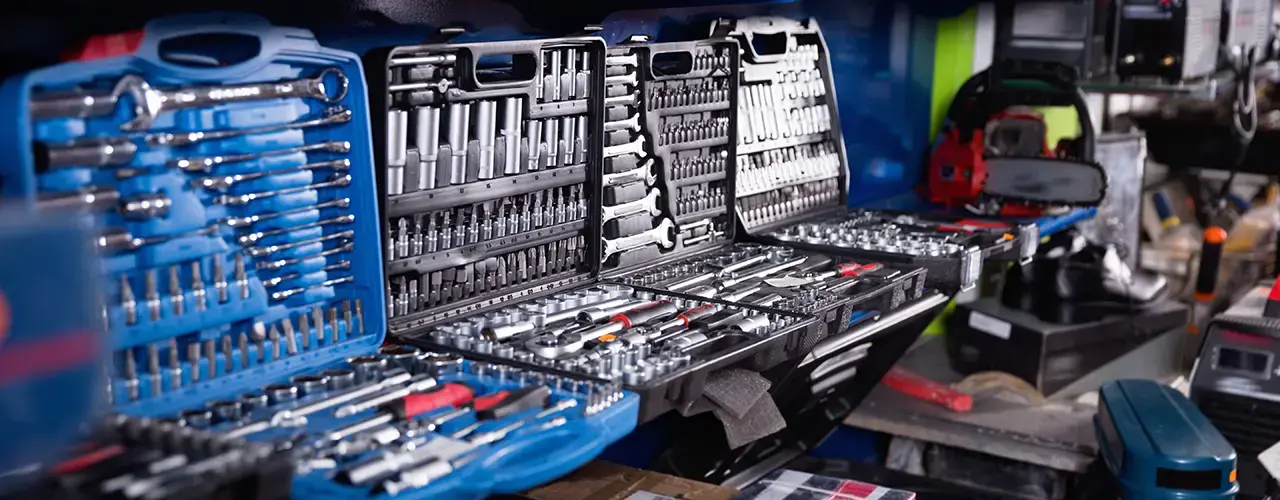 A set of open toolboxes showcasing an assortment of tools, such as hammers, pliers, and screwdrivers, neatly arranged inside.